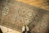 Distressed Serab runner displaying geometric medallions, blush, peach, and oxidized silver hues.