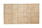 Distressed vintage Persian rug, light beige with faint brown tree of life motif, foundation visible, 2'5