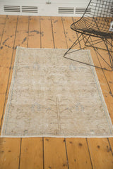 Distressed vintage Persian rug showing tree of life motif, textured pile, foundation, and fringe.