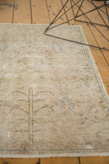 Worn texture of a beige vintage Meshed rug, revealing Tree of Life design and visible foundation.