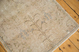 Distressed vintage rug texture, showing brown Tree of Life and blue floral motifs.