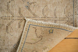 Distressed vintage Meshed rug corner revealing foundation, woven back, and fringe.