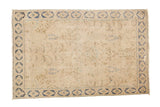 Faded distressed Persian rug with beige tree of life, floral motifs, and blue border, 3'1