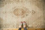Vintage Distressed Oushak rug featuring a complex layered medallion and light-colored lattice spandrels.