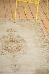 Distressed vintage Oushak rug, featuring stepped medallion, lattice spandrels, and muted border.
