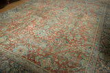 Distressed Mahal carpet pile with time-softened terra cotta, teal, and ivory floral patterns.