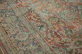 Distressed Mahal carpet's ornate floral motifs and border, with foundation showing through faded terra cotta and teal.