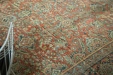 Distressed vintage Mahal carpet detail showing terra cotta, teal curvilinear floral patterns, even wear.