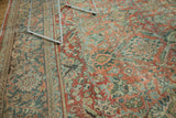 Distressed Mahal carpet with faded terra cotta and teal curvilinear motifs; even wear.