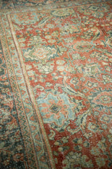 Distressed vintage Mahal carpet pile, showing terra cotta and teal floral motifs with even wear.