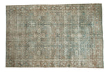 Distressed vintage Tabriz carpet with allover faded floral design in soft blues and brown tones.