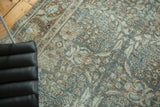 Distressed vintage Tabriz carpet with faded sky blue, coffee brown floral motifs and visible foundation.