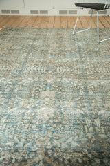 Distressed Tabriz carpet, an allover faded floral pattern in soft blues and browns.