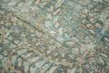 Worn sky blue, brown floral motifs on distressed vintage Tabriz carpet pile.