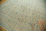 Faded Herati motif and scrolling blue vinery border on this distressed Tabriz carpet.