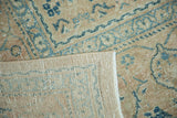 Vintage distressed Tabriz rug's hand-knotted foundation and pile with beige and blue Herati design.