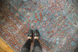 Vintage distressed Meshed carpet with sky blue field, pomegranate red motifs, and low pile texture underfoot.