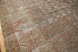 Distressed texture and nuanced Herati motif with exposed foundation on an antique Malayer rug.