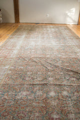 Antique Malayer rug detail, featuring distressed texture, faded Herati pattern, and soft hues.