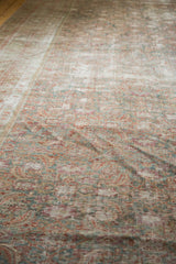 The distressed texture and subtle herati pattern of the antique Malayer rug.