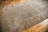 Distressed antique Malayer rug border, with artistic wear and faded red, slate blue patterns.