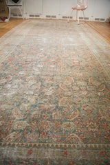 Distressed Persian Malayer rug texture showing faded slate blue and wine red herati motif.