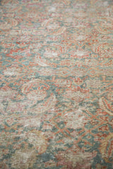 Textural detail of a distressed antique Malayer runner with faded greens, reds, and ivory.