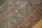 Distressed Antique Malayer rug detail, featuring Herati motifs, exposed foundation, and faded tones.