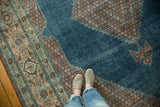 Watery blue field and blush floral spandrel on a distressed vintage Mahal carpet.