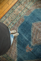 Distressed watery blue field with stepped contour and ornate red floral border.