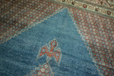 Distressed Mahal rug's watery blue field with stylized red motif and stepped corner of red-blue florals.