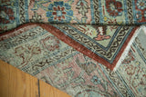 Distressed Vintage Mahal carpet corner, displaying faded floral texture, secure red edge, and fringe.