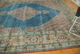 Distressed Mahal rug corner, showing floral spandrel and border in aqua, blush, and rich reds.