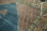 Distressed Mahal carpet with faded blue field and floral motif border in blush and aqua.