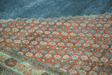 Detail of distressed Mahal carpet: pomegranate red, aqua blue floral motifs, and green border.