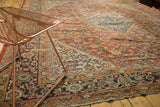 Antique Persian Mahal rug corner detail: navy turtle samovar border, terracotta Herati pattern.
