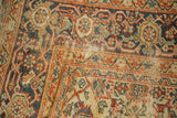 Intricate terra cotta and navy Herati motif on antique Mahal rug with low pile.