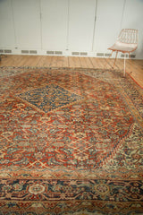 Antique Mahal carpet featuring a stepped navy medallion, rust Herati pattern, and turtle border.