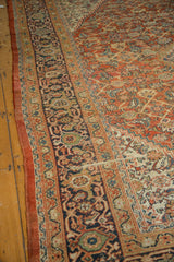 Navy turtle samovar border and Herati motif on an antique Mahal rug's low pile.