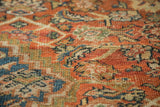 Detailed view of antique Mahal rug's low pile Herati motif in terra cotta and blue.