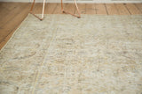 Distressed vintage Sparta carpet displaying faded allover pattern with beige, ivory, and saffron tones.