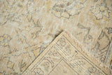 Distressed Sparta carpet corner: hand-knotted foundation, fringe, and muted allover pattern.