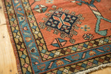 Corner of Vintage Heriz runner: geometric border in sky blue, beige, terra cotta field, and pile.