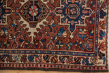 Traditional Heriz-style border and intricate patterns on a vintage Karaja rug in brick red, navy, and ivory.