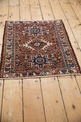 Lower corner of a vintage Karaja rug, showing ivory border, sharp geometric details, and fringe.