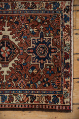 Karaja rug border and field featuring sharp geometric contouring in brick red, navy, ivory.
