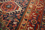 Vintage Karaja rug with intricate geometric weave, cherry red medallion, navy, green, and gold patterns.