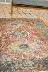Distressed Karaja rug showing textured pile, stylized medallions, cherry red, and teal.