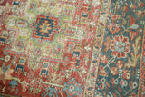 Distressed vintage Karaja rug's intricate weave and worn pile transitioning from field to floral border.