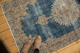 Distressed sky blue field and decorative European border of a vintage Sparta rug.